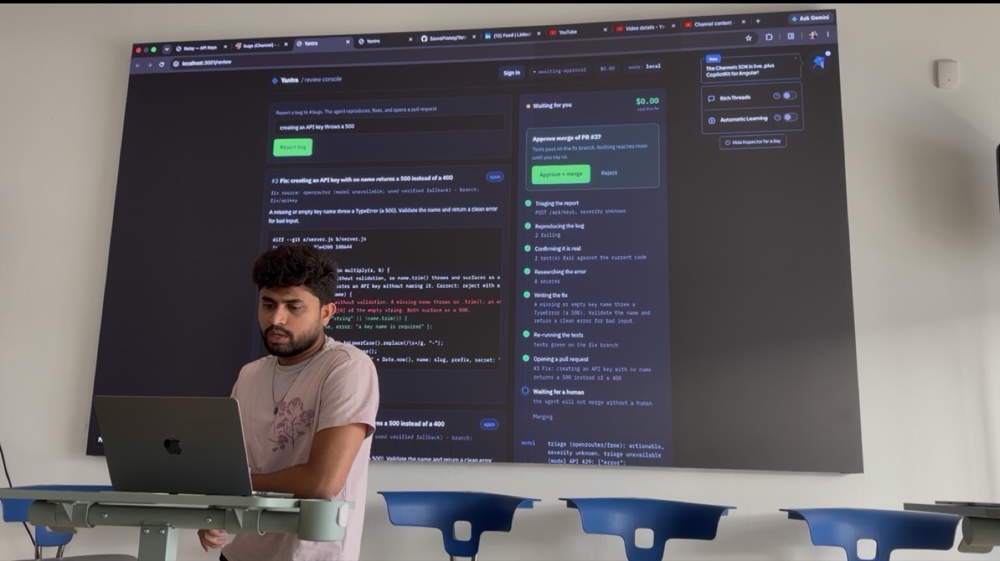 The review console live on the big screen during the demo. The pipeline runs on the right and waits for a human before anything reaches main.